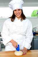 Uniformed female chef in a restaurant kitchen
