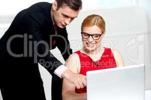Business team in action. Man pointing at laptop