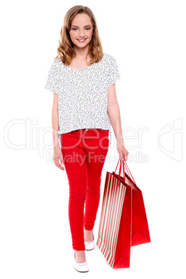 Little girl walking with shopping bag