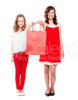 Beautiful teenagers holding shopping bag