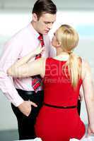 Woman pulling man from his tie. Feeling naughty