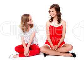 Young cheerful girls sitting together