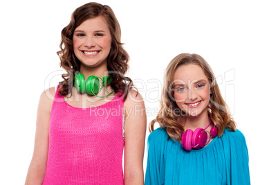 Teenagers posing with headphones around neck