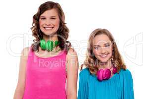 Teenagers posing with headphones around neck