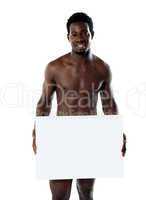 Naked black man holding blank billboard