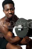 Powerful young man lifting weights