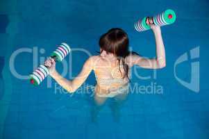 Pretty girl doing aqua aerobic exercise