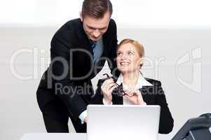 Business people at work. Male pointing at laptop