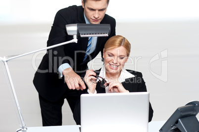 Man pointing finger at laptop screen