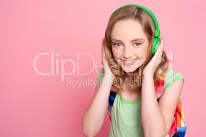 Pretty teenager enjoying music on headphones