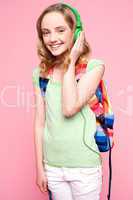 Teenager with backpack listening to music