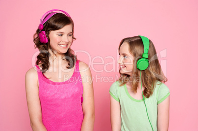 Two teenage friends enjoying music together