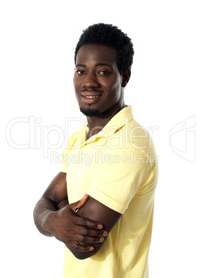 Young happy man posing with crossed arms