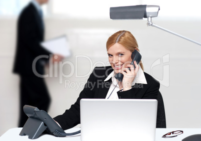 Attractive secretary attending phone call