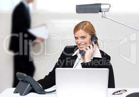 Attractive secretary attending phone call