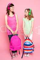 Beautiful teenagers holding school bag