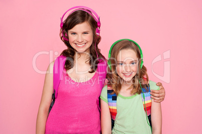 Sisters standing together and enjoying music