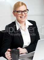 Beautiful businesswoman holding coffee cup