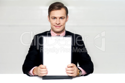 Corporate man showing blank clipboard