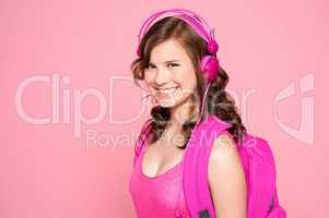 Attractive schoolgirl listening to music