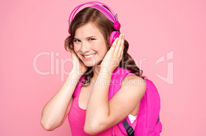 Schoolgirl enjoying music and smiling