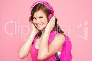 Schoolgirl enjoying music and smiling