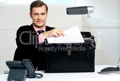 Male executive keeping documents safely