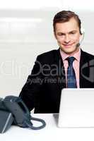 Male executive wearing headsets and smiling