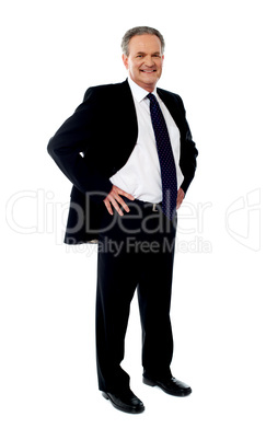 Senior businessman posing with hands on his waist