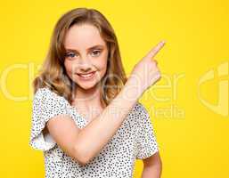 Smiling caucasian girl indicating upwards