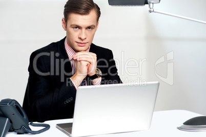 Businessman sitting in front of laptop