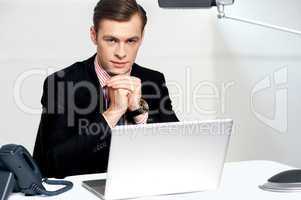 Businessman sitting in front of laptop