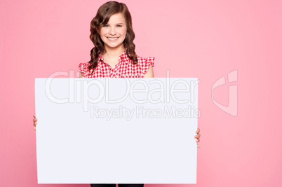 Beautiful girl holding blank billboard