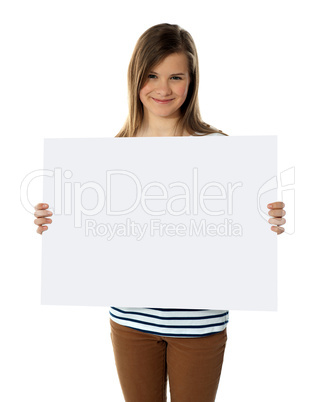 Smiling teenager showing blank white billboard