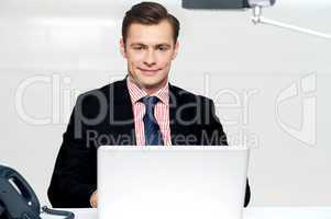 Handsome young businessman with laptop