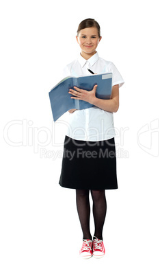 Full length portrait of smiling girl doing homework