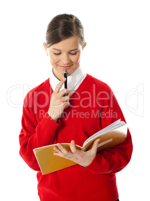 Girl thinking and looking into her notebook