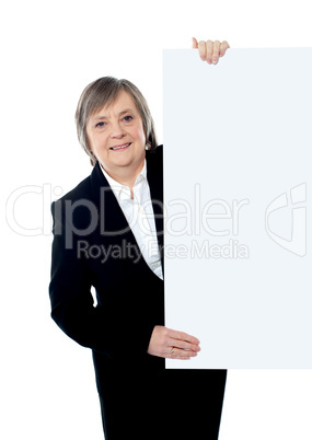 Female executive holding blank whiteboard