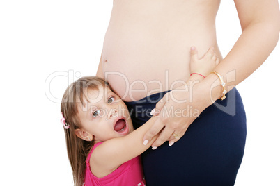 Little cute girl embracing her pregnant mother