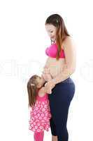 Nice Caucasian woman pregnant with her daughter on the backgroun