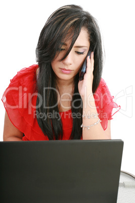 Serious business woman looking at laptop screen while talking on