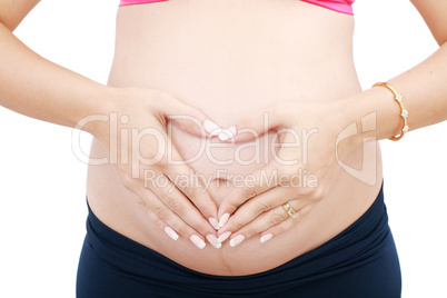 Woman holding her hands in a heart shape on her pregnant belly