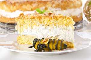 flat cake with an almond and sugar coating and a custard or cream filling