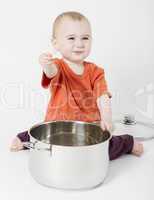 baby with big cooking pot