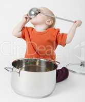 baby with big cooking pot