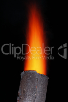 Red torch over metal chimney