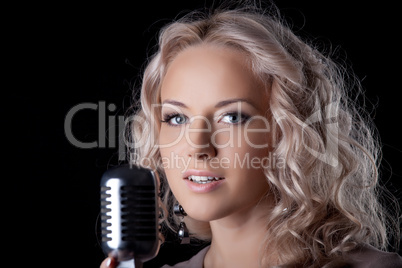 Beautiful young woman with microphone