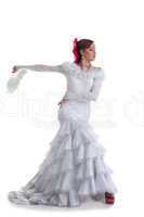 Woman in white dress performing flamenco