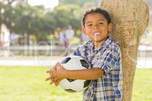 Mixed Race Boy Holding Soccer Ball in the Park