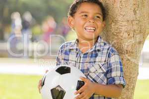 Mixed Race Boy Holding Soccer Ball in the Park